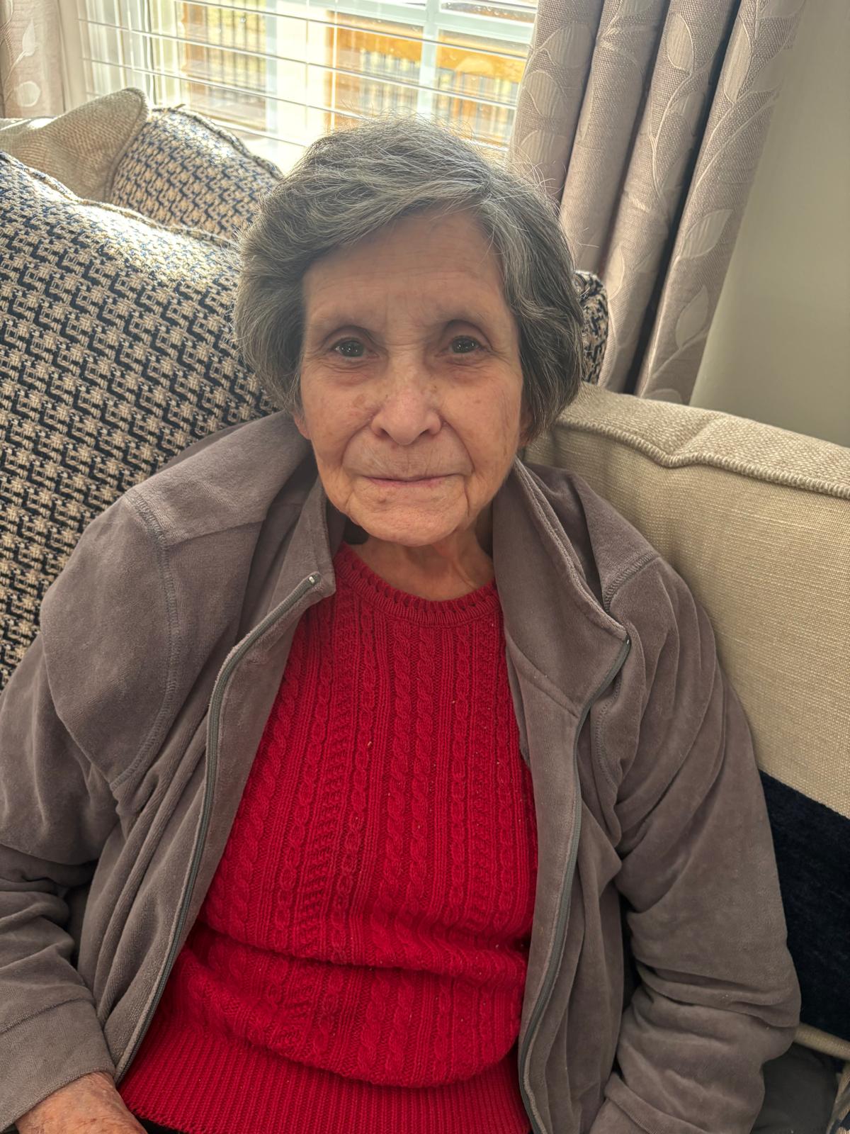 Woman resident relaxing in a sunny common area