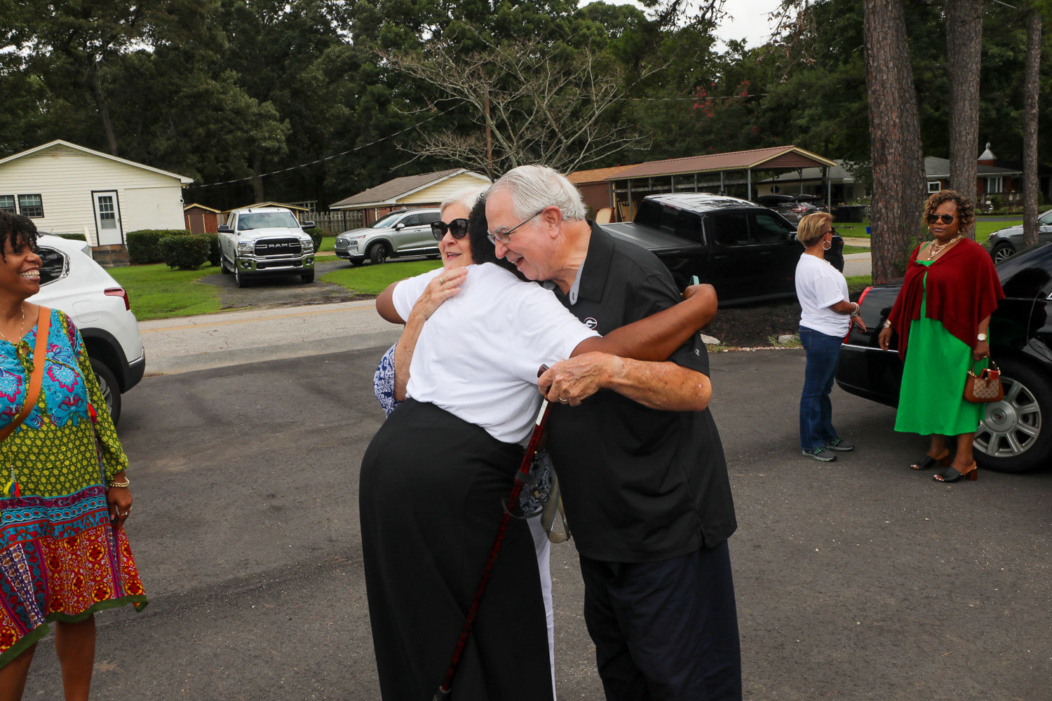 Two guests sharing a warm greeting during the Gracious Senior Living grand opening